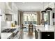 Bright kitchen features marble counters, white cabinets, stainless appliances, and an eat-in breakfast nook with a window at 1720 Barclay Close Nw, Atlanta, GA 30318