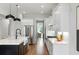 Gourmet kitchen features white cabinets, stainless appliances, marble counters and a view of a dining room and living room at 1720 Barclay Close Nw, Atlanta, GA 30318