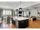 Modern open kitchen flowing into the living area with a large island and farmhouse sink at 1720 Barclay Close Nw, Atlanta, GA 30318