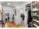 Well-organized walk-in closet adjacent to a laundry room for added convenience at 1720 Barclay Close Nw, Atlanta, GA 30318