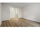 Bedroom with wood-look laminate flooring, light walls, and a closet with mirrored sliding doors at 1923 Brian Way # 1923, Decatur, GA 30033