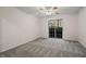 A bright carpeted bedroom provides access to an outdoor living space via sliding glass door at 1923 Brian Way # 1923, Decatur, GA 30033