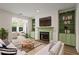 Cozy living room featuring a fireplace with built-in shelving and large windows for ample natural light at 1923 Brian Way # 1923, Decatur, GA 30033