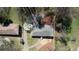 Aerial view of a home with a driveway and solar panels, surrounded by lush greenery and neighboring houses at 3340 Brenda Ln, Lithia Springs, GA 30122