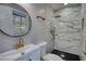 A modern bathroom showcasing a luxury walk-in shower and round mirror at 3340 Brenda Ln, Lithia Springs, GA 30122