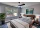 A modern bedroom with a large window, plant, mounted tv and stylish decor at 3340 Brenda Ln, Lithia Springs, GA 30122