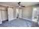 Neutral bedroom featuring a barn door closet, ceiling fan, and en suite bathroom at 3340 Brenda Ln, Lithia Springs, GA 30122