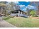 A freshly painted home with a covered patio and a large manicured yard at 3340 Brenda Ln, Lithia Springs, GA 30122