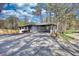 Home featuring a rear patio, large, newly paved driveway and a yard at 3340 Brenda Ln, Lithia Springs, GA 30122
