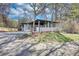 A home with fresh exterior paint, a rear patio, and a large, grassy yard at 3340 Brenda Ln, Lithia Springs, GA 30122
