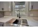 Farmhouse sink featuring a gooseneck faucet and stone countertops complements the spacious kitchen at 3340 Brenda Ln, Lithia Springs, GA 30122
