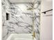 Bathroom featuring marble-style tile, bronze fixtures, and rainfall showerhead at 3340 Brenda Ln, Lithia Springs, GA 30122