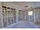 A view of an unfinished room showing the wall studs and concrete flooring at 3340 Brenda Ln, Lithia Springs, GA 30122