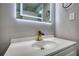Close-up of a bathroom vanity with a white countertop, gold faucet, and an illuminated mirror at 3340 Brenda Ln, Lithia Springs, GA 30122