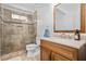 Beautiful bathroom features a tiled walk-in shower with a glass door, a classic vanity, and modern fixtures at 3897 Beacon St, Marietta, GA 30062