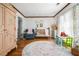 Bright Bedroom with hardwood floors, area rug, crib, and natural light through the floral curtains at 3897 Beacon St, Marietta, GA 30062