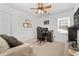 This bedroom features neutral walls, a ceiling fan, and a cozy corner desk setup for work or gaming at 3897 Beacon St, Marietta, GA 30062