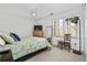 Cozy bedroom with a patterned comforter, natural light from the window, and simple, functional decor at 3897 Beacon St, Marietta, GA 30062