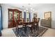Formal dining room featuring a wood table, chairs, a china cabinet and stylish chandelier at 3897 Beacon St, Marietta, GA 30062