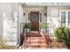 Inviting front entrance with brick steps, a dark wood door with sidelights, and decorative planters at 3897 Beacon St, Marietta, GA 30062