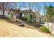 Beautiful home with steps leading to the front door and an attached two-car garage on a sloping lawn at 3897 Beacon St, Marietta, GA 30062