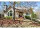Charming home features a tan exterior, arched window, mature landscaping, and a welcoming front entrance at 3897 Beacon St, Marietta, GA 30062