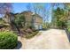 Spacious driveway leads to an attached two-car garage with a manicured garden along the driveway at 3897 Beacon St, Marietta, GA 30062