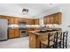 Eat-in kitchen featuring oak cabinets, a tiled backsplash, and a stainless steel refrigerator at 3897 Beacon St, Marietta, GA 30062