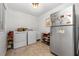 Functional laundry room with washer, dryer, storage shelves, and tiled floor for easy maintenance at 3897 Beacon St, Marietta, GA 30062