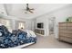 A well-lit primary bedroom featuring a ceiling fan, an ensuite bath, and a comfortable sitting area at 3897 Beacon St, Marietta, GA 30062