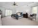 Spacious primary bedroom with tray ceilings, ceiling fan, and large windows allowing for plenty of natural light at 3897 Beacon St, Marietta, GA 30062