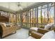 Relaxing screened porch with comfortable wicker furniture and views of the surrounding trees and greenery at 3897 Beacon St, Marietta, GA 30062
