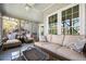 Inviting screened-in porch with comfortable seating, a ceiling fan, and serene views of the surrounding nature at 3897 Beacon St, Marietta, GA 30062
