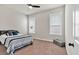 A cozy bedroom features plush carpet, natural light from two windows, and a ceiling fan at 359 Woodridge Pass, Canton, GA 30114