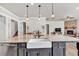 Kitchen island with farmhouse sink, stainless steel dishwasher and pendant lighting at 359 Woodridge Pass, Canton, GA 30114