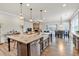 Open-concept kitchen features an island with a farmhouse sink and pendant lighting at 359 Woodridge Pass, Canton, GA 30114