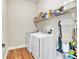 Bright laundry room featuring a front-load washer and dryer and laminate flooring at 359 Woodridge Pass, Canton, GA 30114