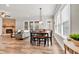 Open-concept living room and dining area with fireplace and lots of natural light at 359 Woodridge Pass, Canton, GA 30114