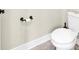 Close up of a toilet with a white tank and seat, set against a neutral wall at 359 Woodridge Pass, Canton, GA 30114