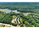 Scenic aerial view of a lake, surrounded by a tree-lined landscape and recreational areas at 3965 Hamilton View Way, Dacula, GA 30019
