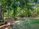 Green backyard and border of tall trees provide a shaded and natural environment at 3965 Hamilton View Way, Dacula, GA 30019