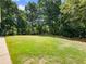 Expansive backyard with lush green grass and mature trees, perfect for outdoor activities and relaxation at 3965 Hamilton View Way, Dacula, GA 30019