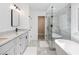 Modern bathroom featuring a walk-in shower, soaking tub, marble countertops and floors at 3965 Hamilton View Way, Dacula, GA 30019