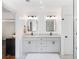 Bright bathroom featuring double sinks with modern fixtures, vanity, and neutral color palette at 3965 Hamilton View Way, Dacula, GA 30019