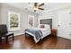 Bedroom featuring wood floors, natural light, a ceiling fan, and a gray upholstered headboard bed at 3965 Hamilton View Way, Dacula, GA 30019