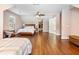 Bedroom featuring wood floors, natural light, a ceiling fan, and a walk in closet at 3965 Hamilton View Way, Dacula, GA 30019