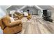 Upstairs bonus room with modern flooring and comfortable furniture perfect for entertaining at 3965 Hamilton View Way, Dacula, GA 30019