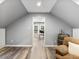Bright bonus room with hardwood floors and barrel accent, perfect for a rec or play area at 3965 Hamilton View Way, Dacula, GA 30019