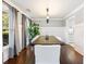 Elegant dining room featuring hardwood floors, modern lighting, and a large window at 3965 Hamilton View Way, Dacula, GA 30019