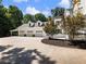 Exterior view of the home's large garage with a spacious paved driveway at 3965 Hamilton View Way, Dacula, GA 30019